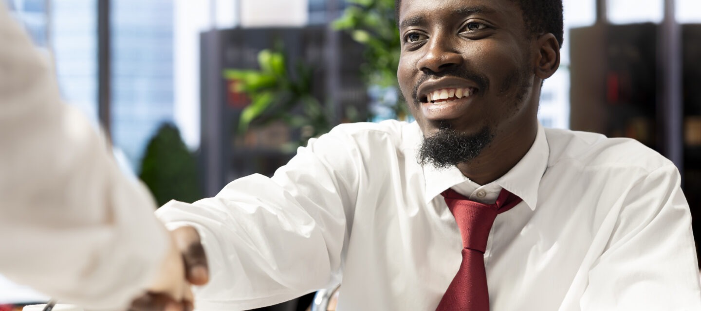 HR consultant greeting a successful candidate with a handshake